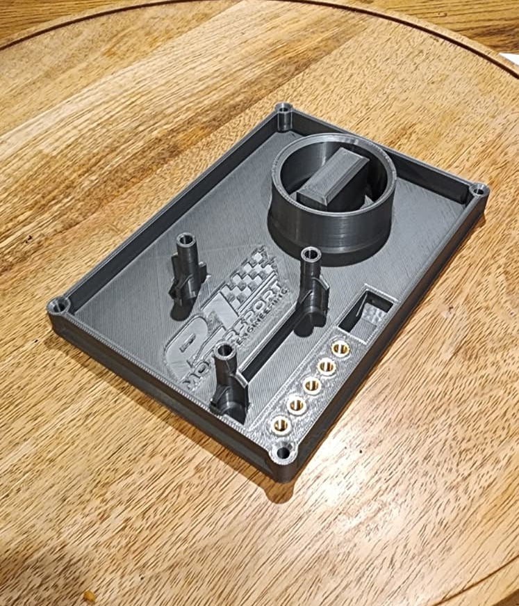 Rotax carburetor workstation showing threaded jet holders and fuel catch tray